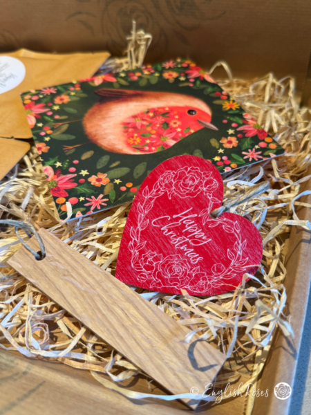 Inside the Christmas letterbox gift with the robin design greetings card, 'Happy Christmas' Wooden Tag and wooden name label.